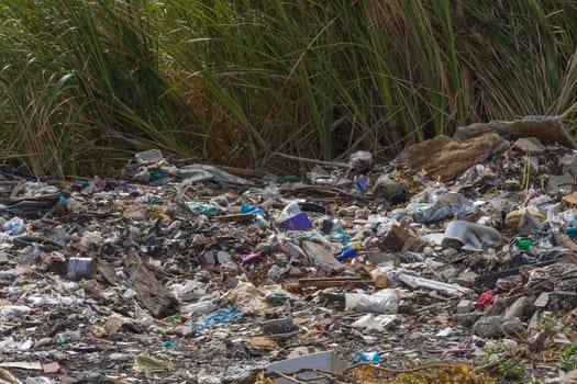 Garbage and junk dump to the landfill in field it illegal, hazardous and dangerous for environment