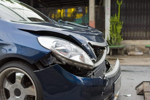 Car crash from car accident on the road in a city between saloon versus pickup wait insurance.