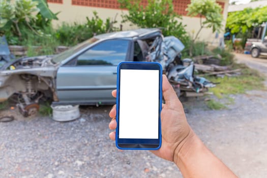Person hand holding smartphone or mobile phone with white screen using on road