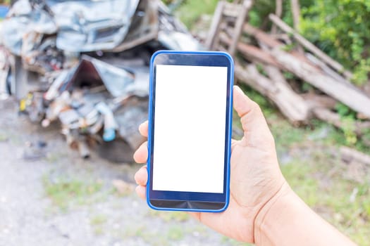 Person hand holding smartphone or mobile phone with white screen using on road