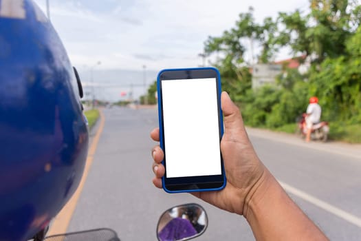 Person hand holding smartphone or mobile phone with white screen using on road