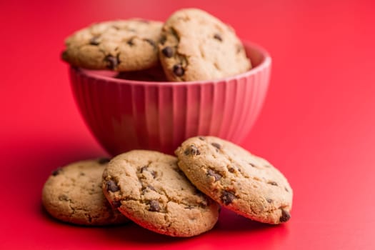 Chocolate chip cookies on a red background.