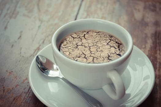 Dry cracked land soil in summer no rain reflection on coffee , process in vintage style