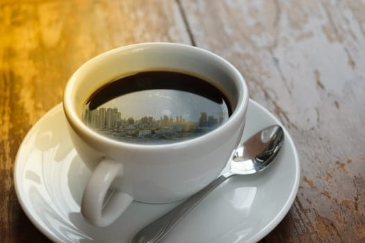 Sunshine morning time and city reflection on coffee , process in soft orange sun light style