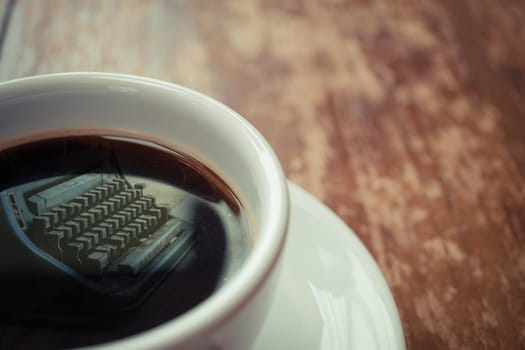 Typewriter reflection on Coffee in white cup on wood table , process in vintage style