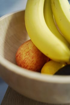 wooden bowl with yellow bananas red apples avocado lemon fruits vegetables healthy fibre pomelo vitamin c immune full care. High quality photo