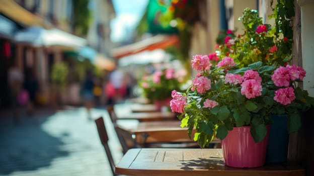 Pink flowers in a pot on a table in a street cafe. High quality photo