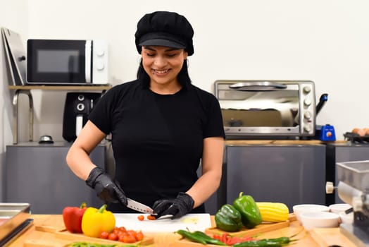 Mexican woman laughing during cooking tacos in the kitchen