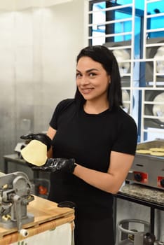 Mexican woman making tacos in a kitchen of a mexican cafe