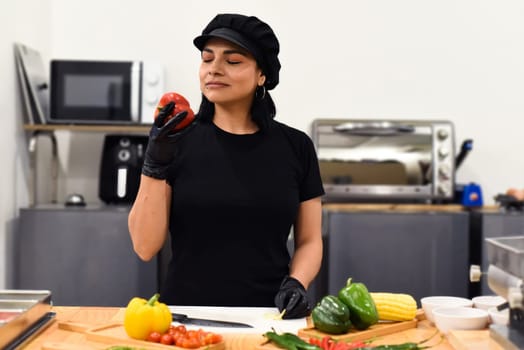 Mexican woman laughing during cooking tacos in the kitchen