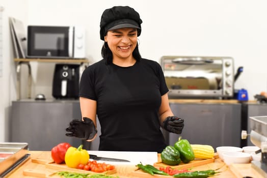 Mexican woman laughing during cooking tacos in the kitchen