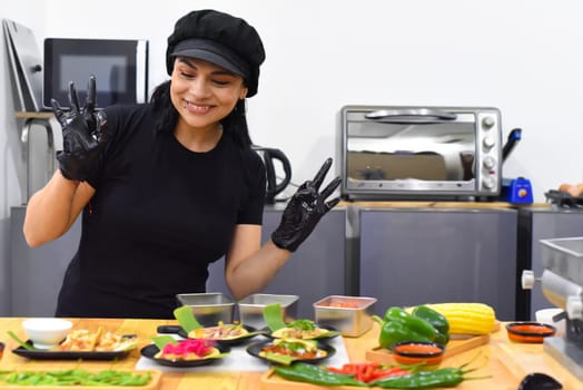 Mexican woman laughing during cooking tacos in the kitchen