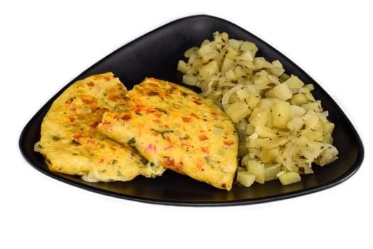 Mexican omelet with potato on black plate isolated on white background top view