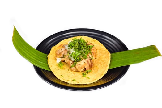 Tacos insurgentes with pulled pork and onion on black plate isolated on white background top view