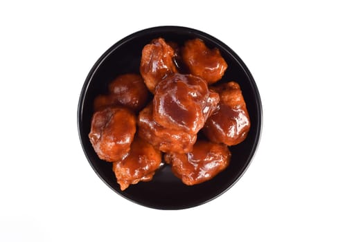Polanco chicken with mexican secret sauce on black plate isolated on white background