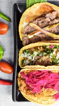 Tacos with sauces on grey background top view closeup