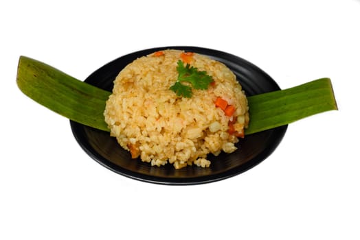 Mexican vegetarian rice with vegetables on black plate isolated on white background top view