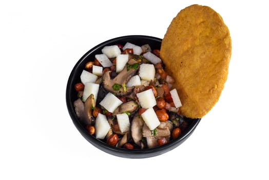 Mexican dish Roma on black plate top view with cherry tomatoes and chili pepper isolated on white background