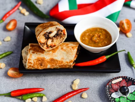 Mexican burrito with chicken, rice,beans and cheese served with sauce barracha