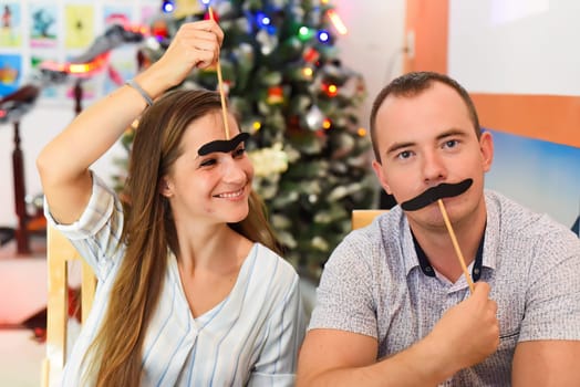 Two friends Russian and Slovak having fun in against chistamas tree at home