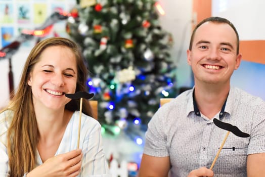 Two friends Russian and Slovak having fun in against chistamas tree at home