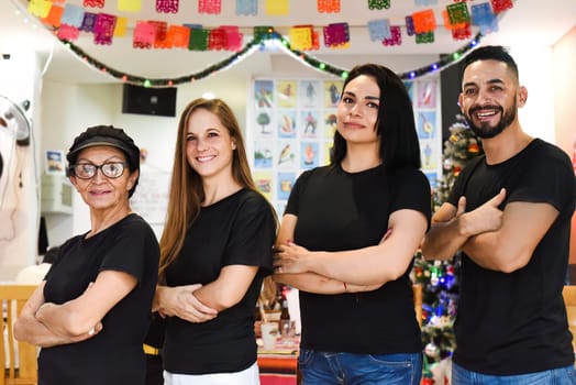 Mexican team of people in Mexican cafe standing together