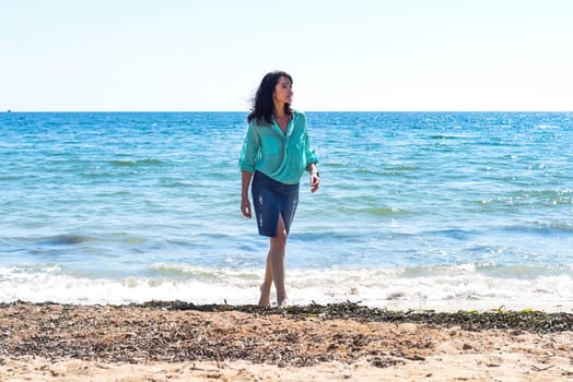 45 years old Russian woman standing in Japanese sea and looking away