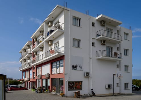 Modern architecture showcases a colorful facade and inviting balconies under a clear blue sky.
