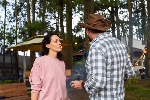 Smoking man and his wife arguing and talking