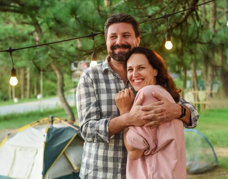 Young married couple feel happy and smile, standing in the forest in the evening