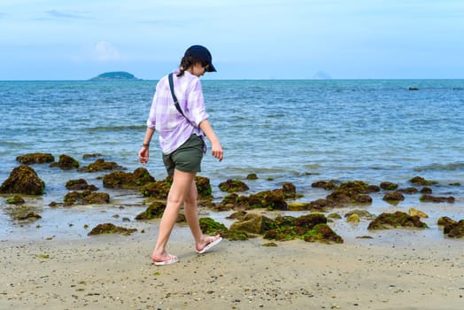 Young slender woman walking to the beach of South China sea of Nha trang Vietnam