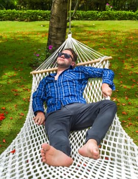 Young man freelancer resting on hammock