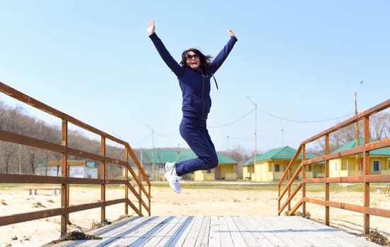 Cheerful 45 y.o. Russian woman jumping and laughing