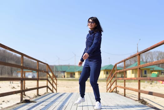 Cheerful 45 y.o. Russian woman running towards the camera and laughingCheerful 45 y.o. Russian woman running towards the camera and laughing