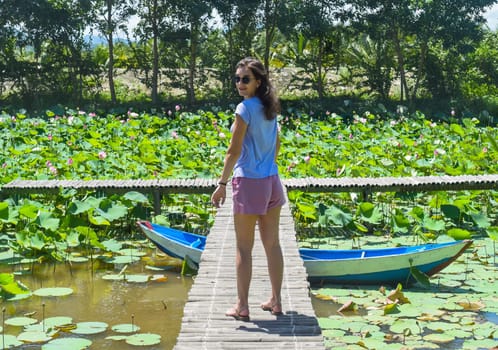 Young woman against Lotus lake in Vietnam