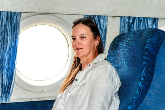 36 years old woman passenger enjoying during a flight in the airplane cabin