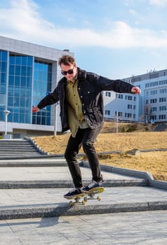 Young man riding a skateboard making tricks and jumps