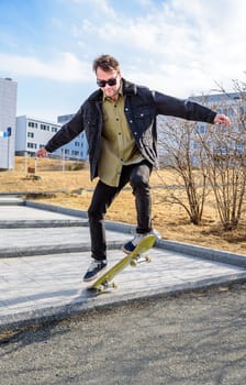 Young man riding a skateboard making tricks and jumps