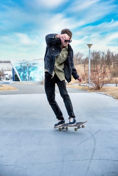 Young man riding a skateboard making tricks and jumps