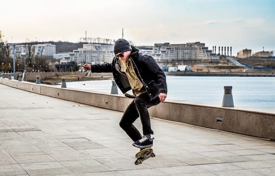 Young man riding a skateboard making tricks and jumps