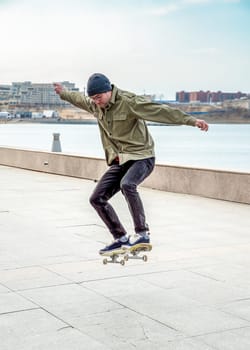 Young man riding a skateboard making tricks and jumps