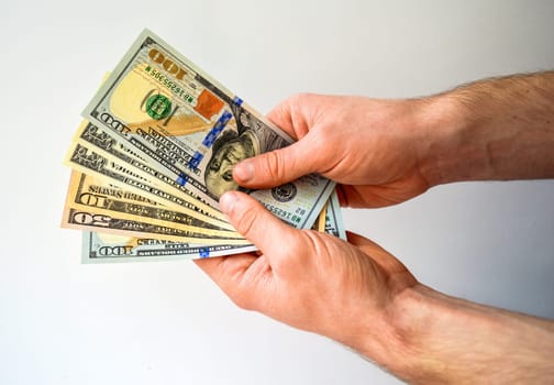 Hand holding money usa dollar isolated on white background