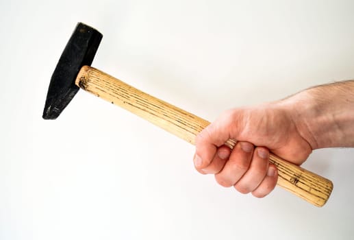 Man's hand holding hammer isolated on white background