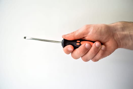 Male's hand holding screwdriver isolated on white background