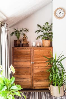 wooden chest of drawers with decorations and flowers in the interior