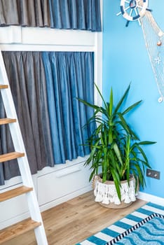 Bunk bed for boyd with blue gray curtains in the bedroom without people