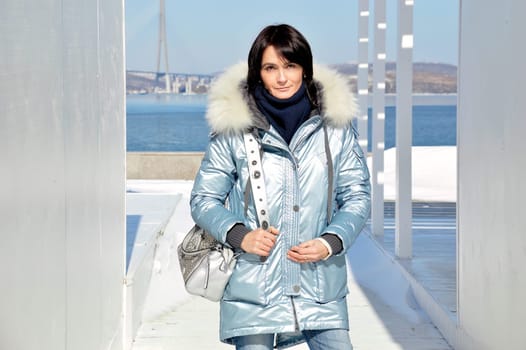 Forty five year old Russian woman smiling, looking at the camera on an early spring  day