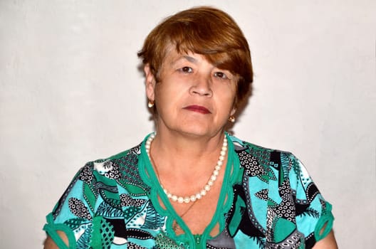 Portrait of Russian 67 years old woman looking away on white background