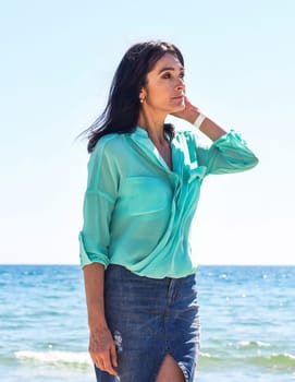 45 years old Russian woman standing in Japanese sea and looking away