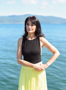45 years old Russian woman laughing and looking away against Japanese sea